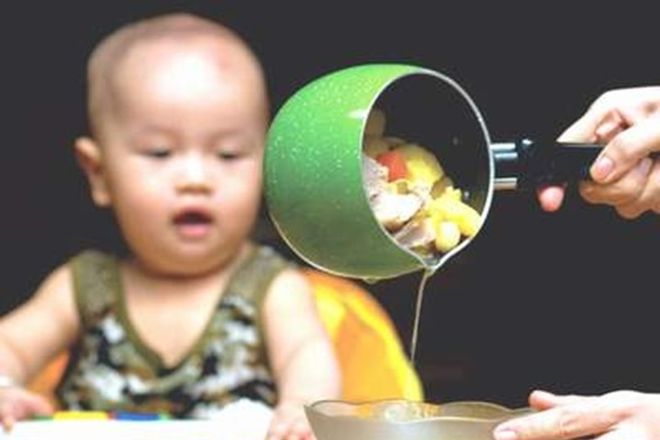 bé nhìn mẹ chắt nước chảo đồ ăn