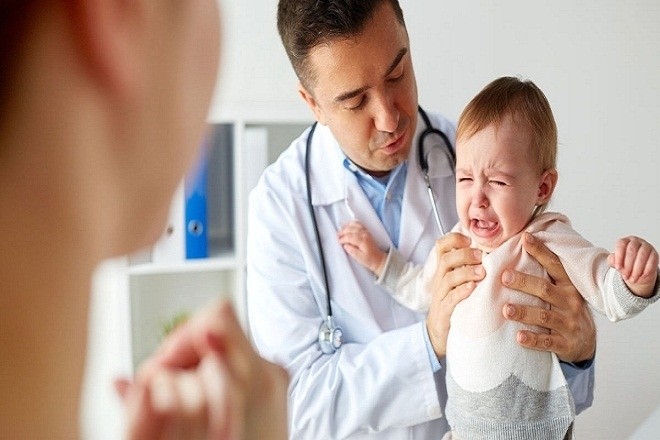 bác sĩ đang bế bé quấy khóc
