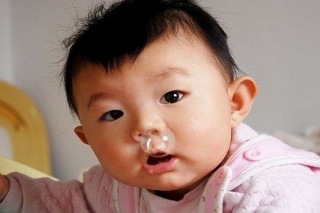 mẹ hãy dùng nước muối sinh lý nhỏ mũi cho trẻ khi trẻ bị sổ mũi