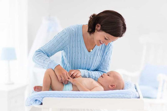 Khi thay tã, bạn hãy trò chuyện và cười với bé.