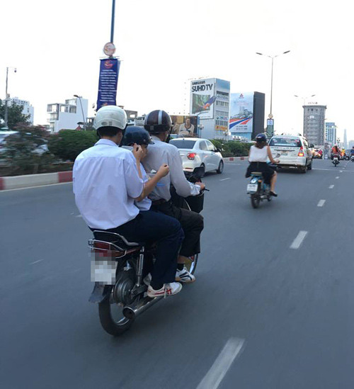 hai hoc sinh vua ngoi tren xe may vua tranh thu an com hop 15094831_1783303475243487_8153578779890665187_n.jpg